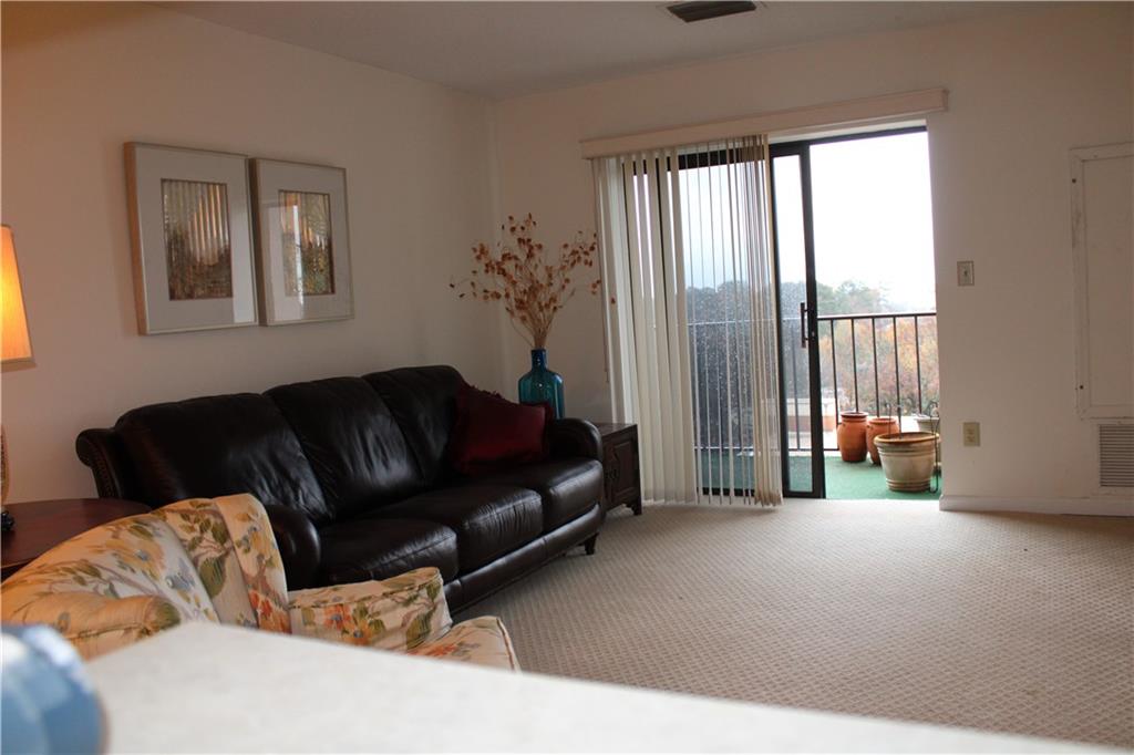 300 Johnson Ferry Road, Unit B802 Atlanta, GA 30328 - Photo 2 of 23 a living room with furniture and a large window