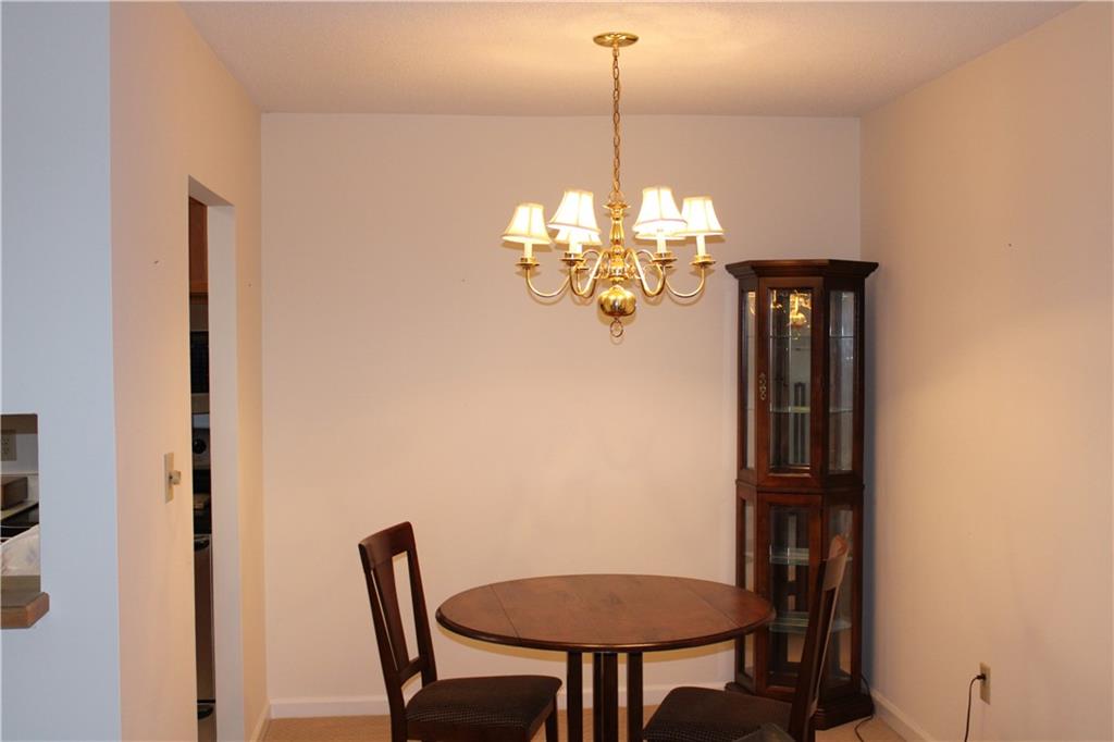 300 Johnson Ferry Road, Unit B802 Atlanta, GA 30328 - Photo 7 of 23 a view of a dining room with furniture and chandelier