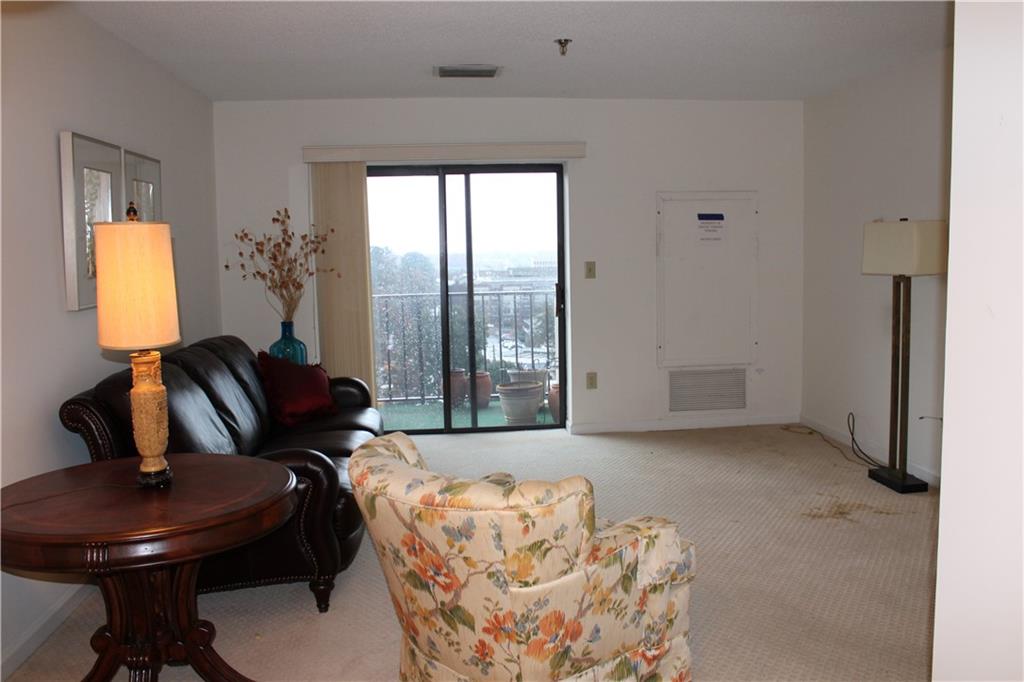 300 Johnson Ferry Road, Unit B802 Atlanta, GA 30328 - Photo 9 of 23 a living room with furniture and a large window