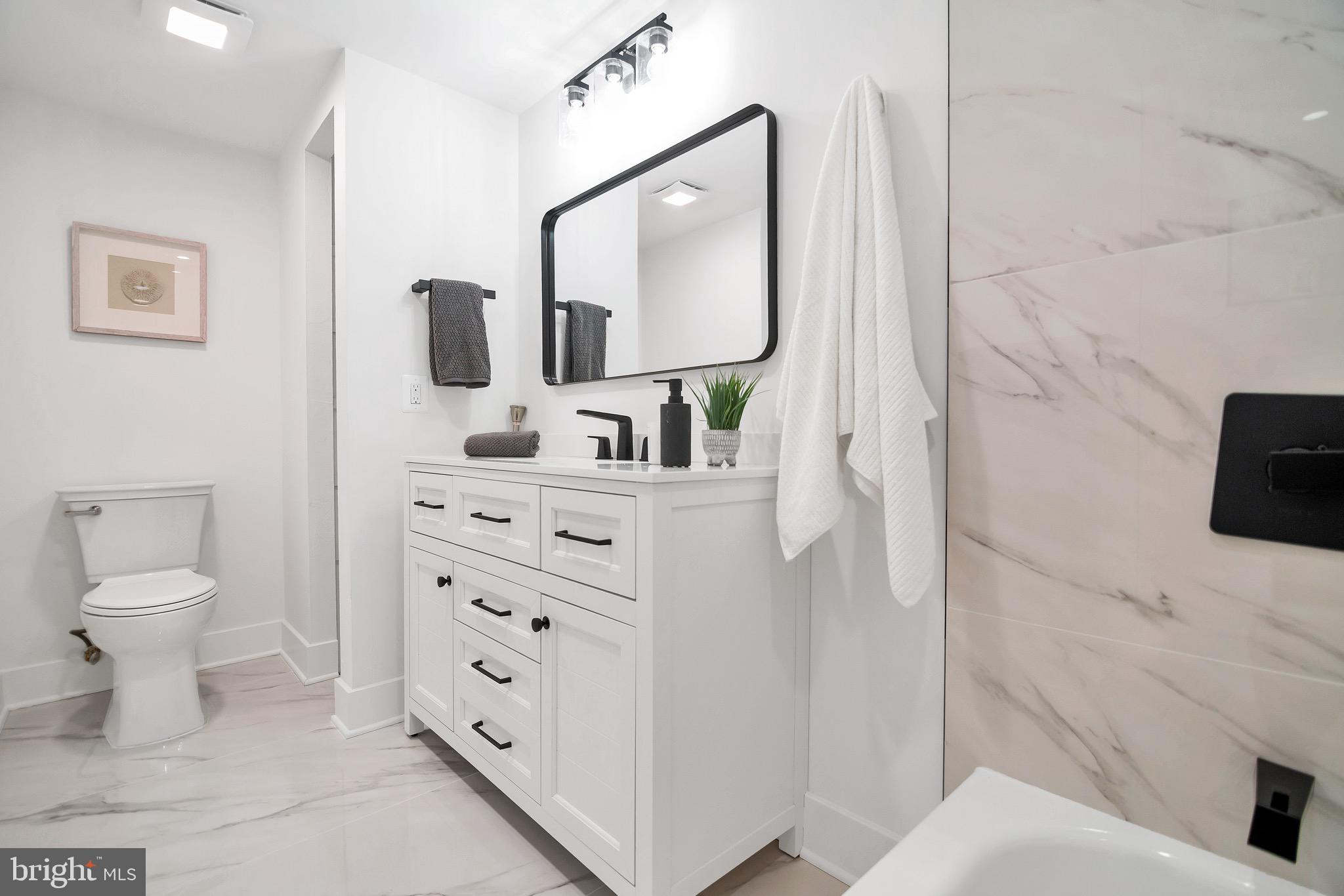 6101 Edsall Road, Unit 602 Alexandria, VA 22304 - Photo 18 of 38 a bathroom with a toilet sink and mirror