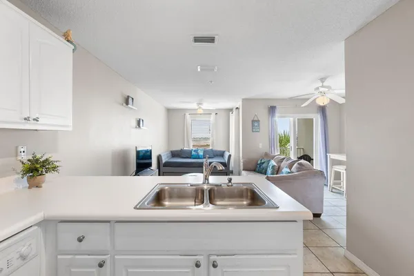 a kitchen with a sink a counter and cabinets