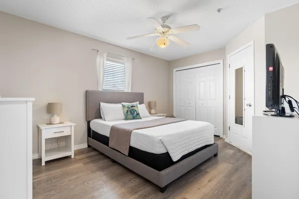 a view of a bedroom with a bed and a chandelier