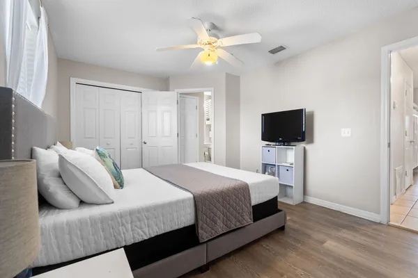 a bedroom with a bed and a flat screen tv