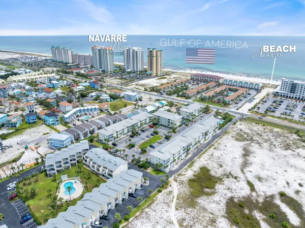 a view of a big yard with an ocean view