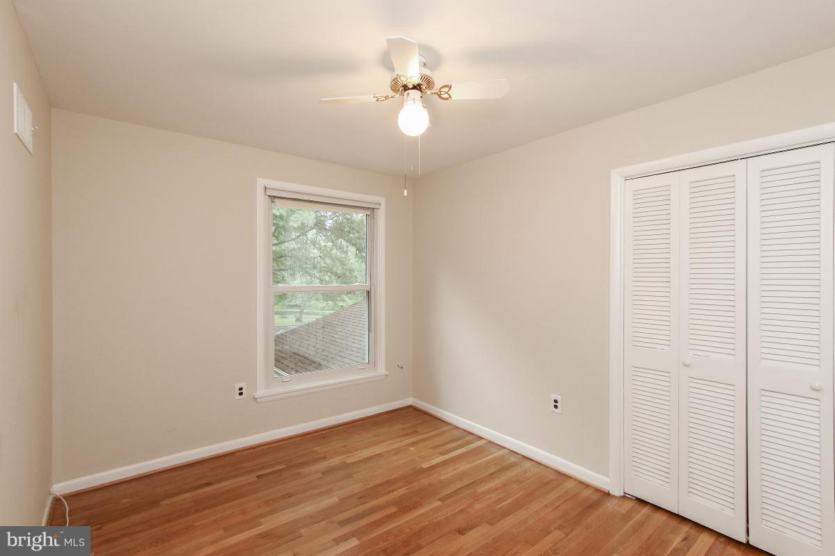 7617 Carteret Road Bethesda, MD 20817 - Photo 22 of 30 a view of an empty room with window and wooden floor