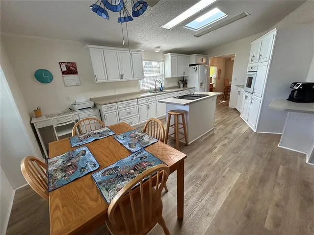 a kitchen with a sink a stove and chairs