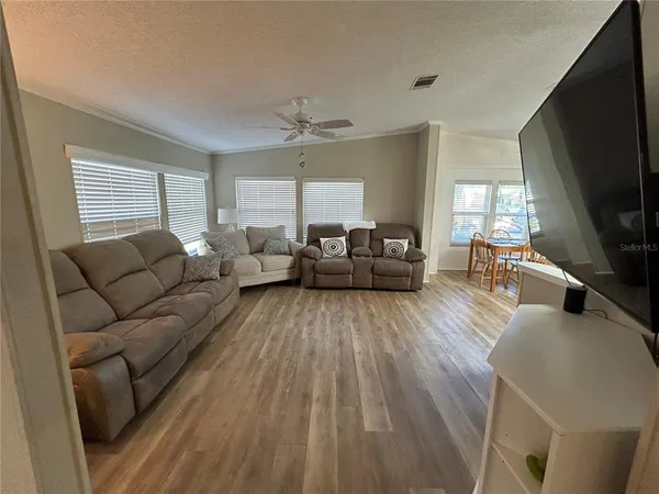a view of a hallway and a livingroom with furniture