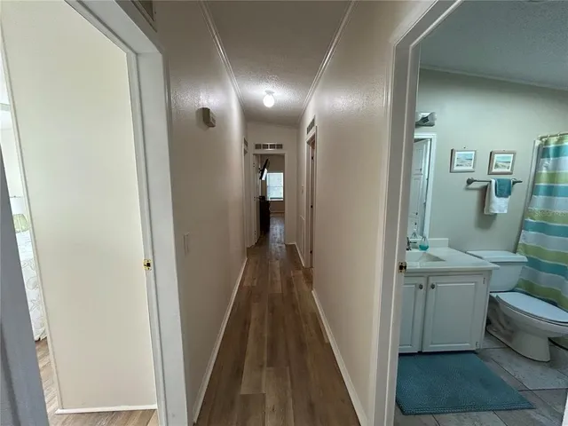 a bathroom with a sink a toilet a mirror and shower curtain