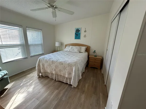 a bedroom with double bed and a chandelier