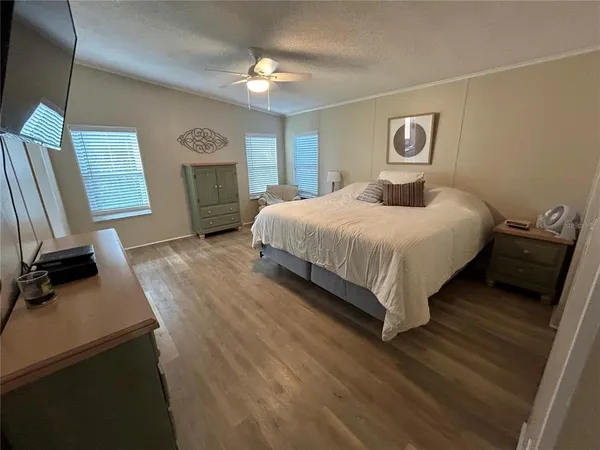 a spacious bedroom with a bed and a chandelier