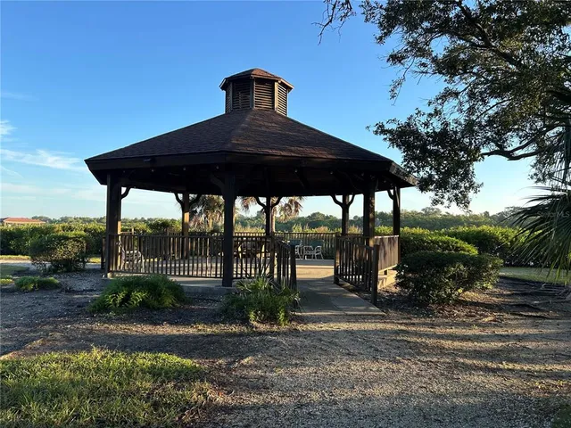 a view of a balcony with wooden floor and lake