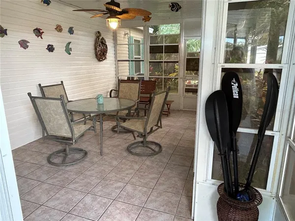 a view of a workspace with furniture and a floor to ceiling window