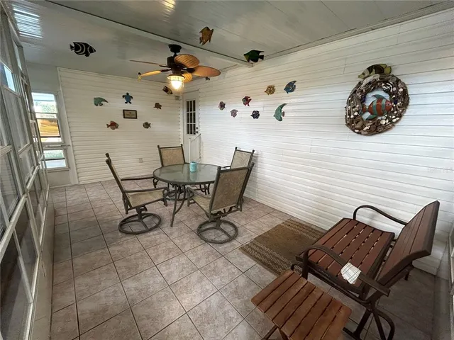 a view of a workspace with furniture and a fan
