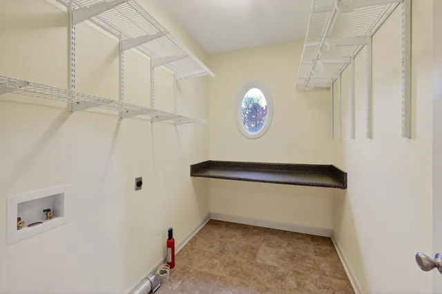 a bedroom with bed and potted plant