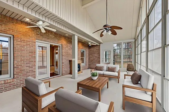 a view of a livingroom with wooden floor and a ceiling fan