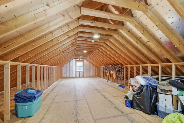a front view of house with yard and trees in the background