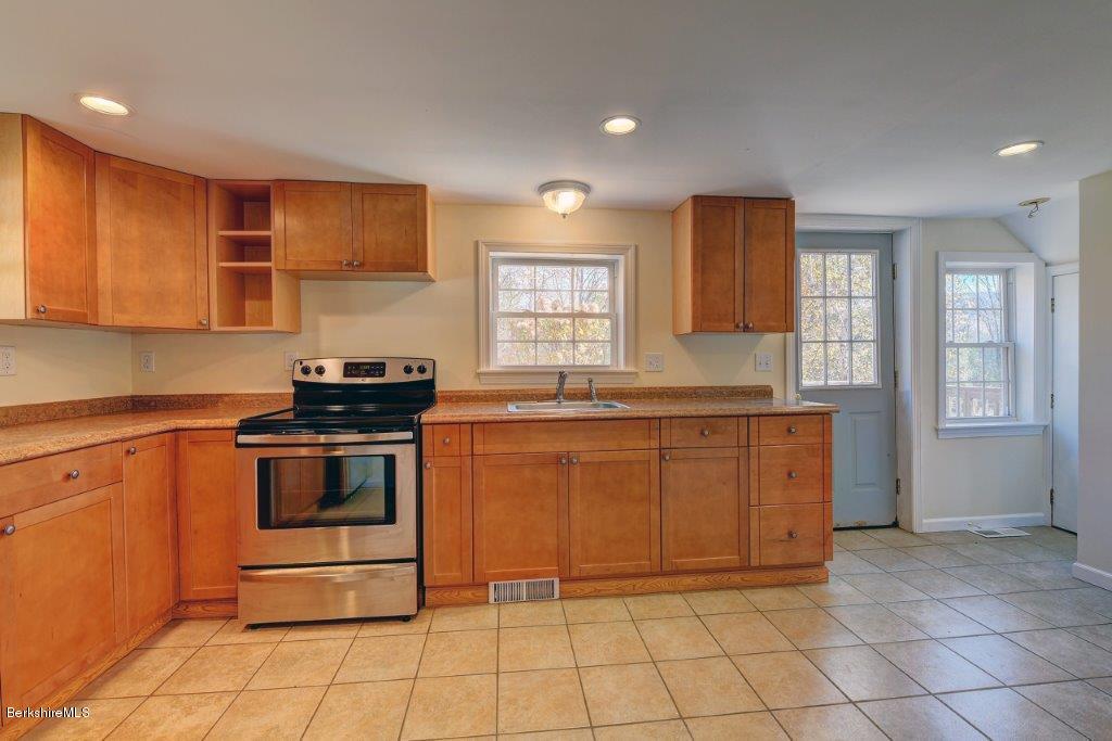 51 Anthony Road Richmond, MA 01201 - Photo 14 of 24 a kitchen with stainless steel appliances granite countertop a stove a sink and a microwave