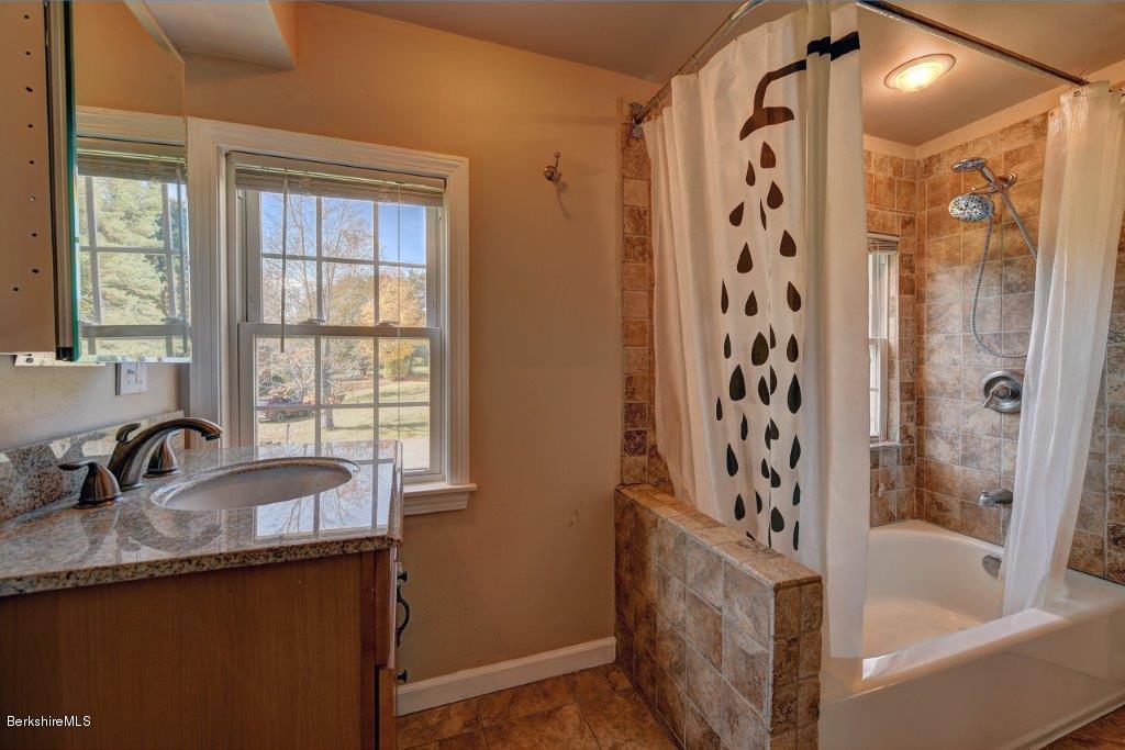 51 Anthony Road Richmond, MA 01201 - Photo 22 of 24 a bathroom with a granite countertop sink a bathtub and shower