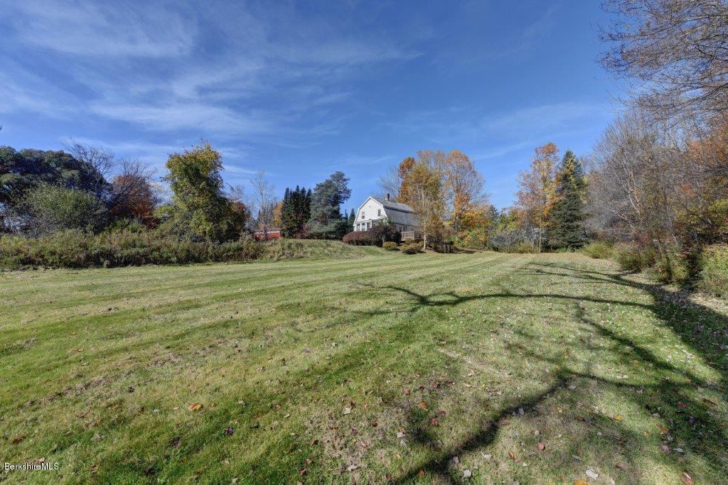 51 Anthony Road Richmond, MA 01201 - Photo 7 of 24 a view of a big yard with a house in the background