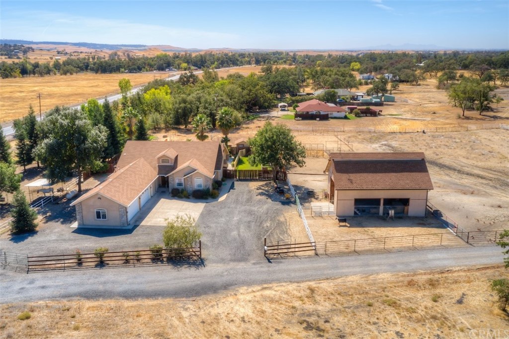 an aerial view of a house with a yard and lake view