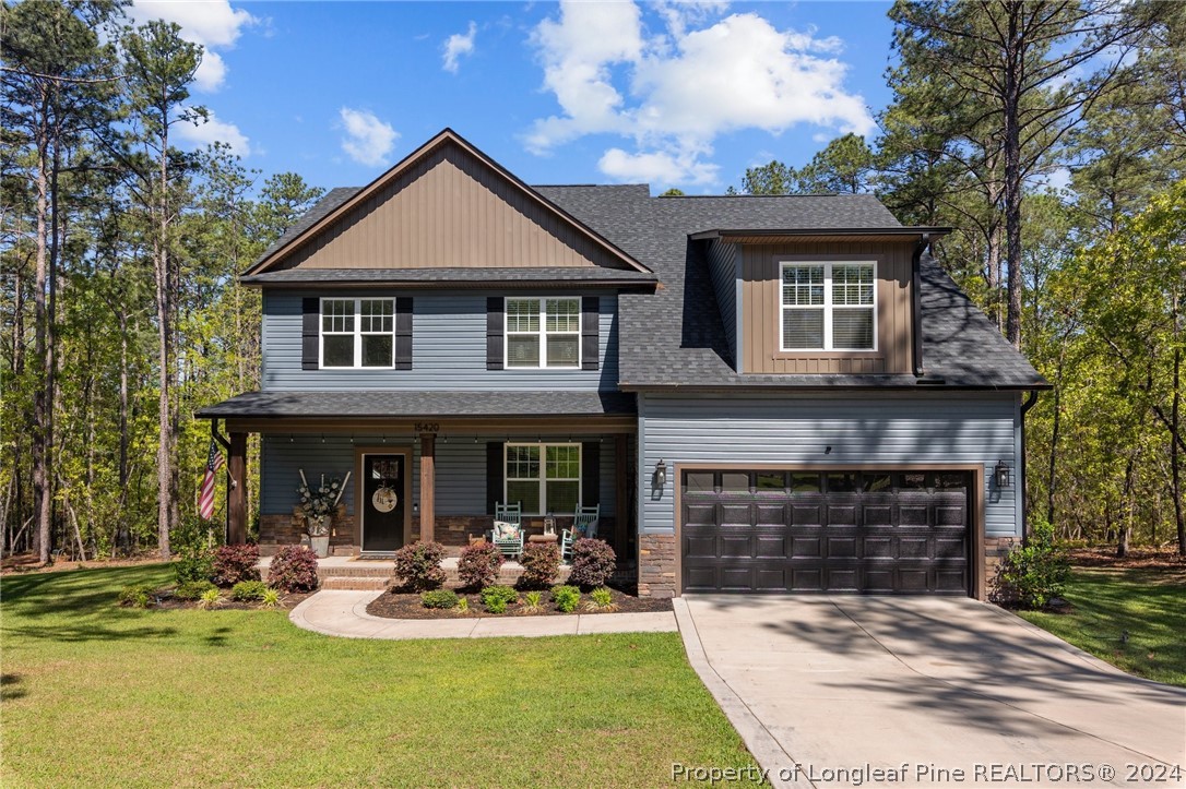 15420 Raccoon Run Road Wagram, NC 28396 - Photo 1 of 39 a front view of a house with a yard table and chairs