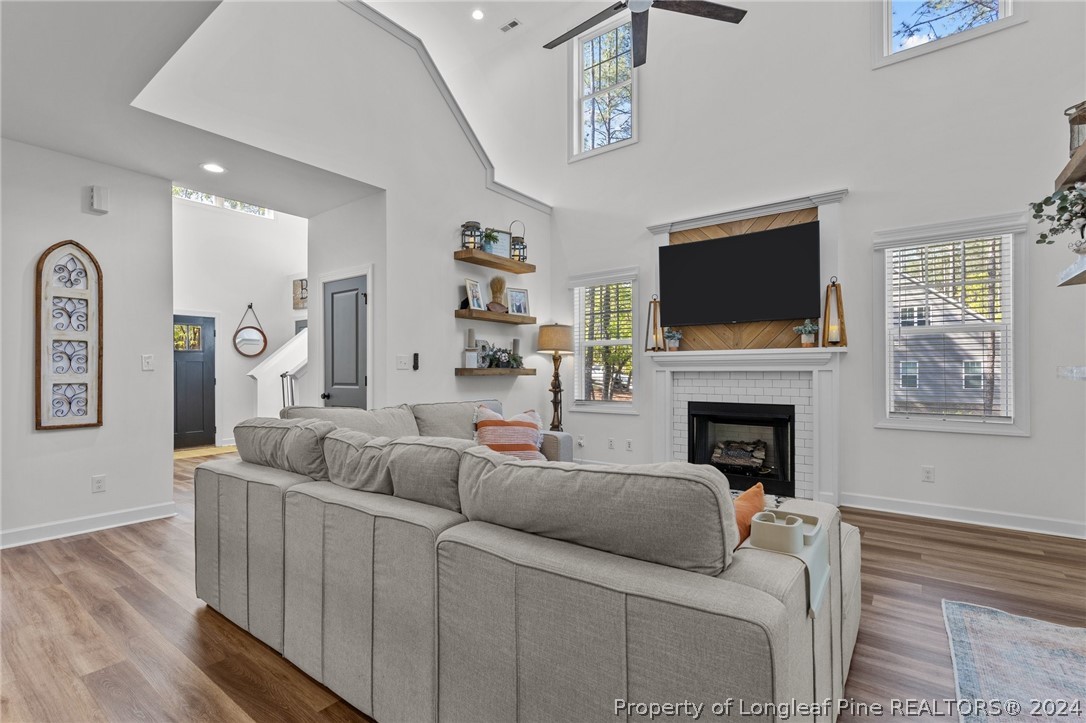 15420 Raccoon Run Road Wagram, NC 28396 - Photo 11 of 39 a living room with furniture a flat screen tv and a fireplace