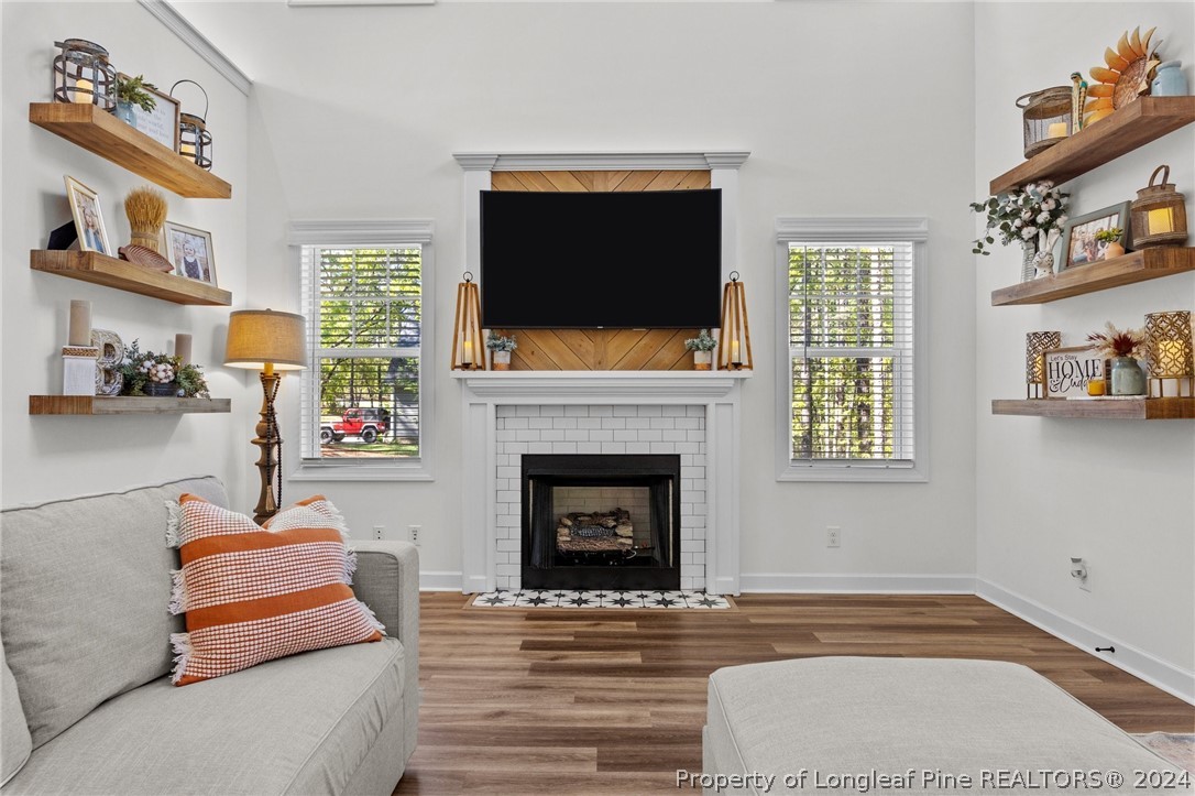 15420 Raccoon Run Road Wagram, NC 28396 - Photo 12 of 39 a living room with furniture and a fireplace