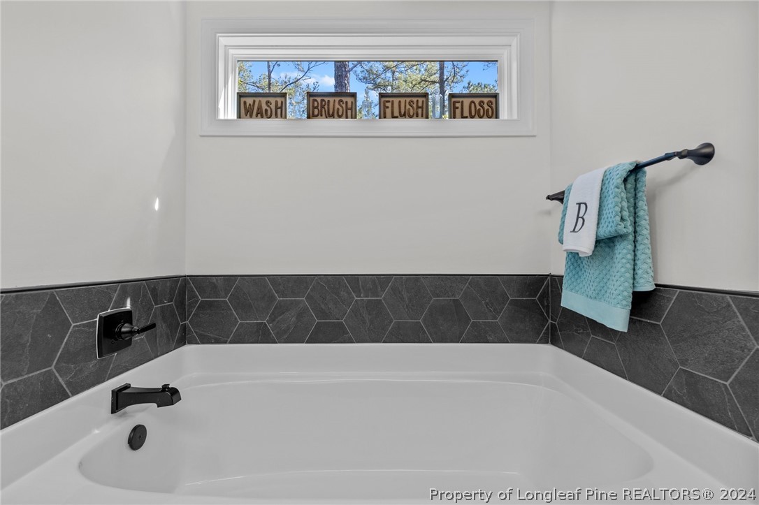 15420 Raccoon Run Road Wagram, NC 28396 - Photo 20 of 39 a bathroom with a bathtub