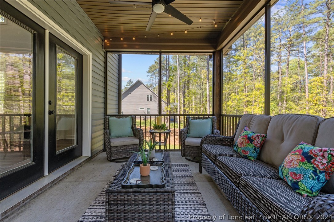 15420 Raccoon Run Road Wagram, NC 28396 - Photo 33 of 39 a living room with furniture and a floor to ceiling window
