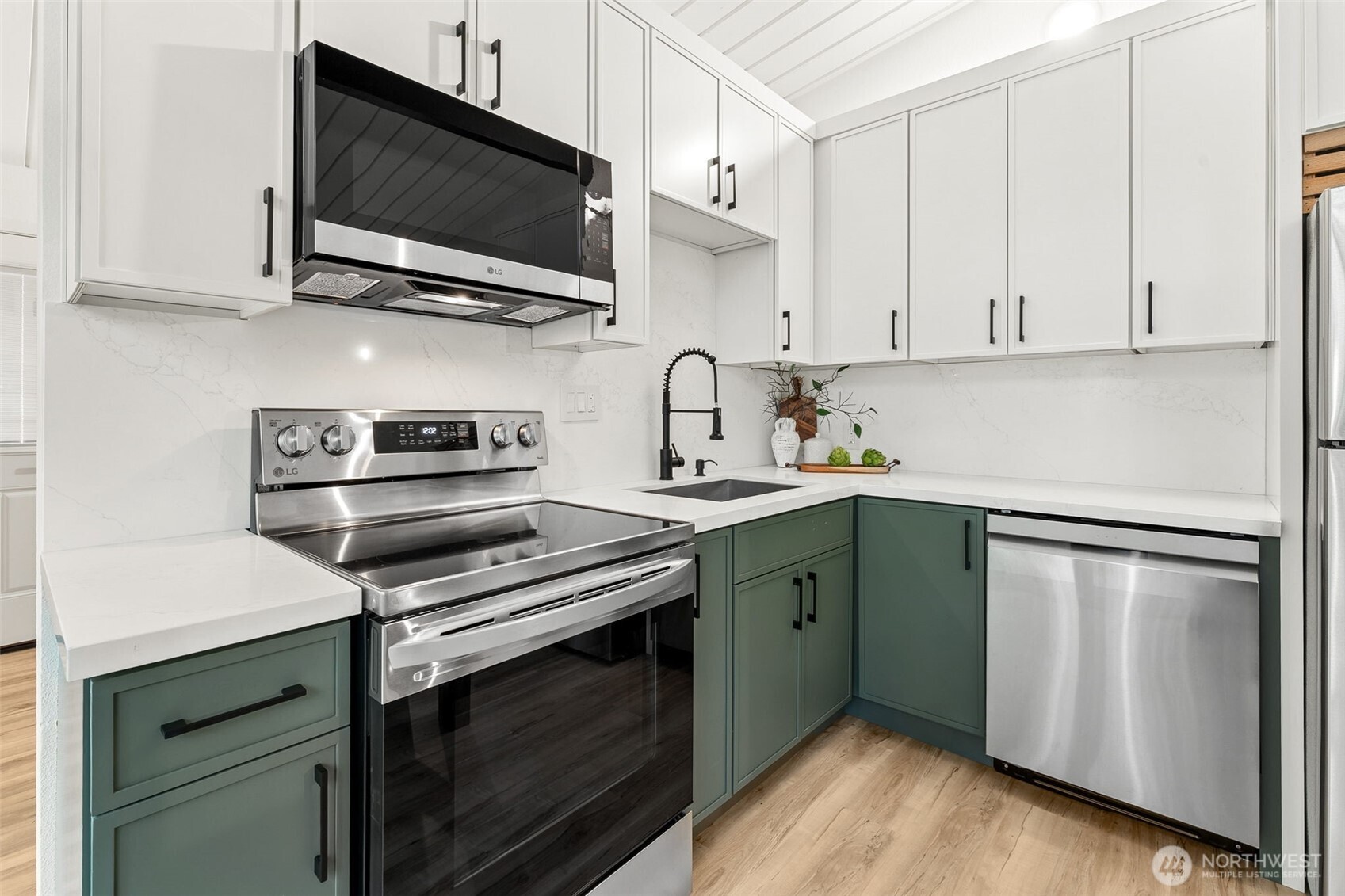 6198 Clover Valley Road Southeast Port Orchard, WA 98367 - Photo 12 of 34 a kitchen with stainless steel appliances a stove microwave and sink