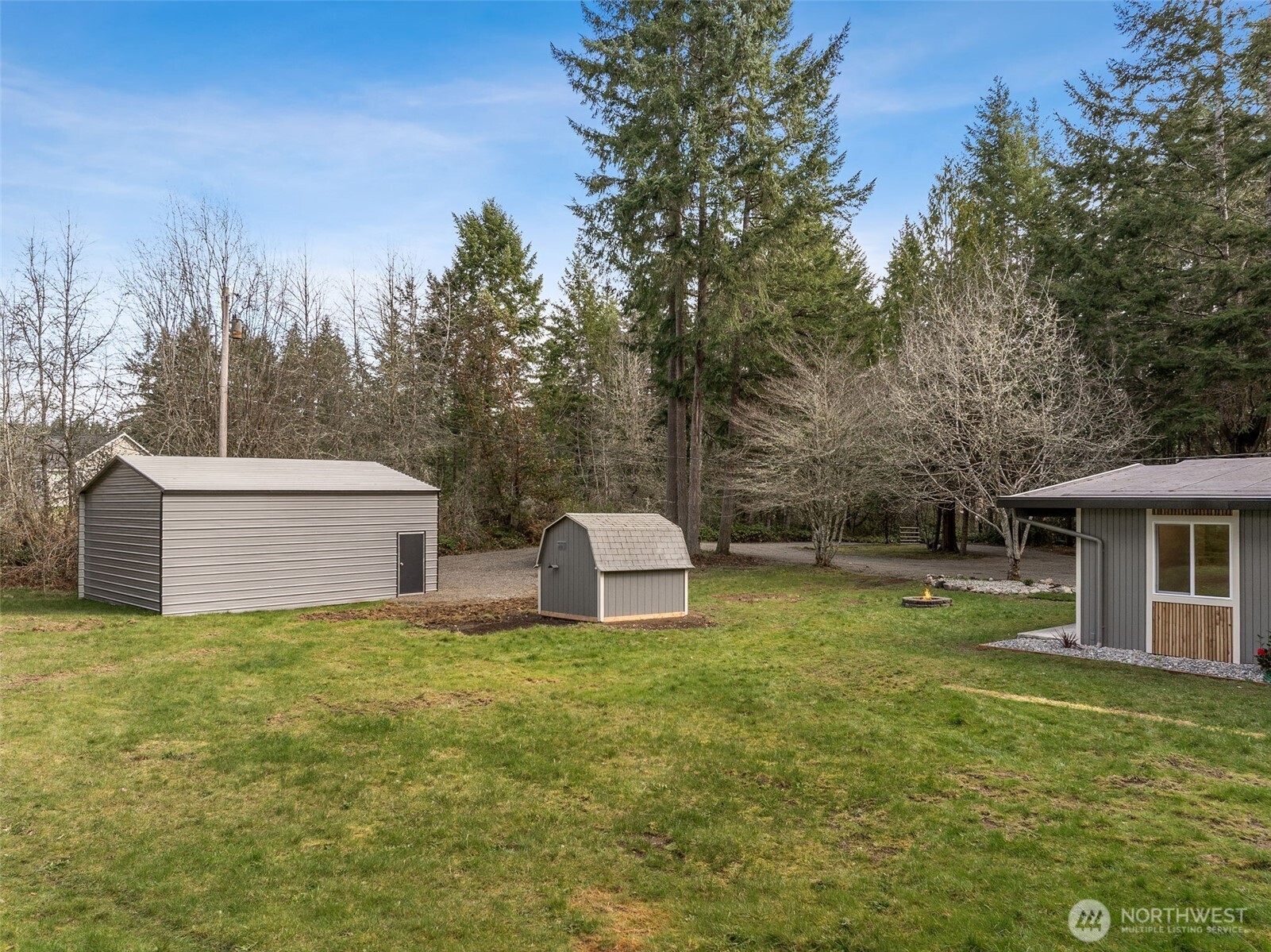 6198 Clover Valley Road Southeast Port Orchard, WA 98367 - Photo 19 of 34 a view of a house with backyard and trees