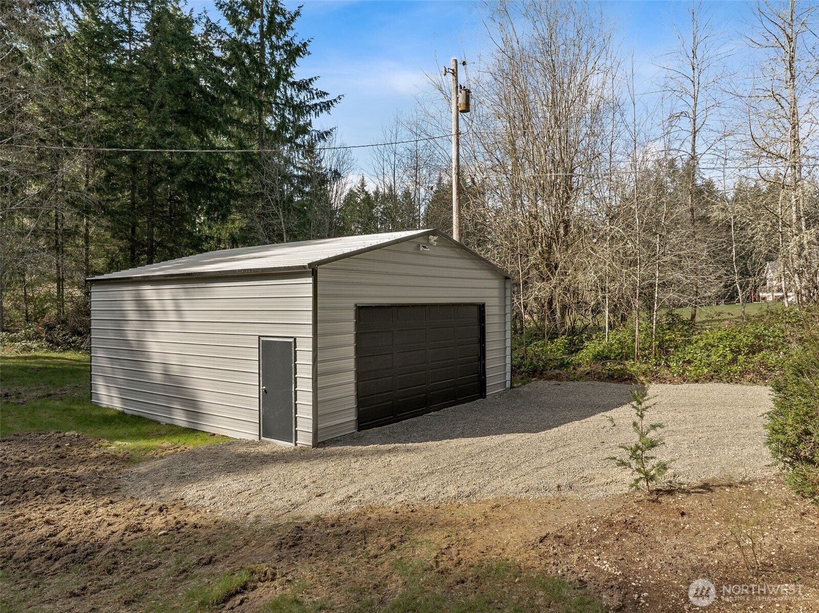 6198 Clover Valley Road Southeast Port Orchard, WA 98367 - Photo 20 of 34 a front view of a house with a yard and garage
