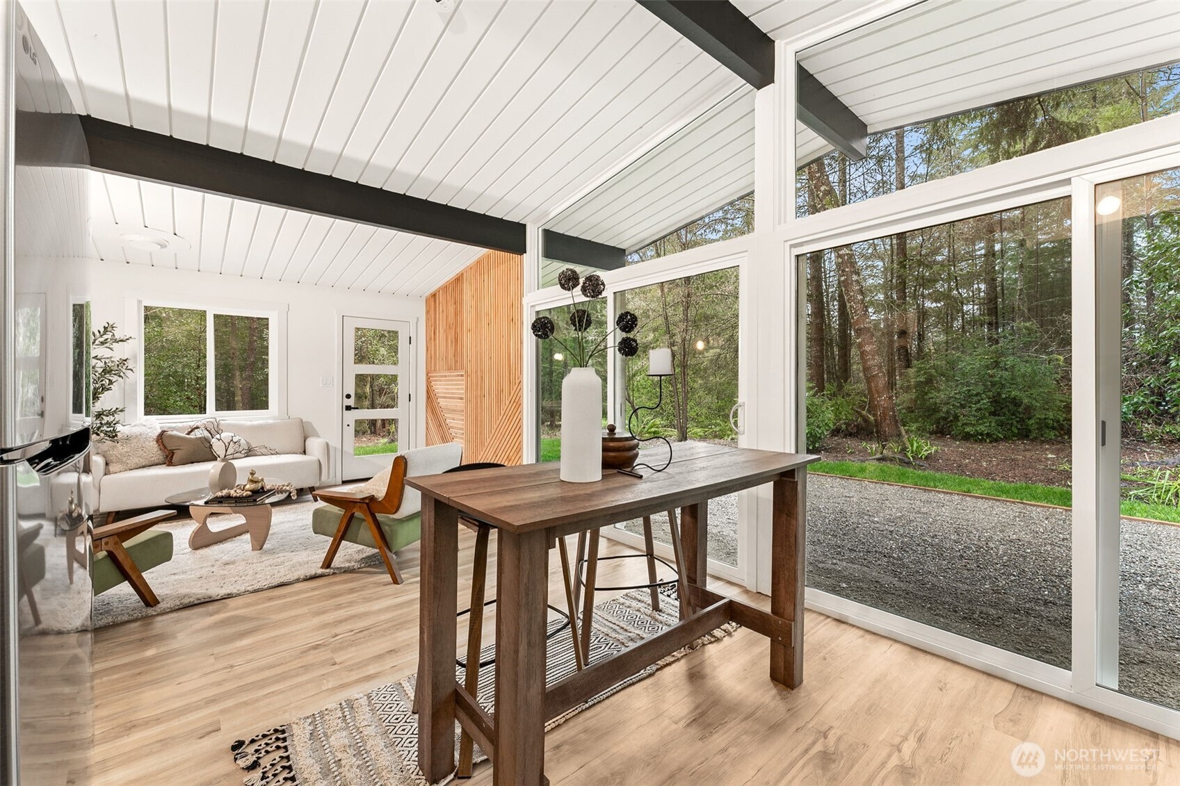 6198 Clover Valley Road Southeast Port Orchard, WA 98367 - Photo 4 of 34 a view of a patio with table and chairs and wooden floor