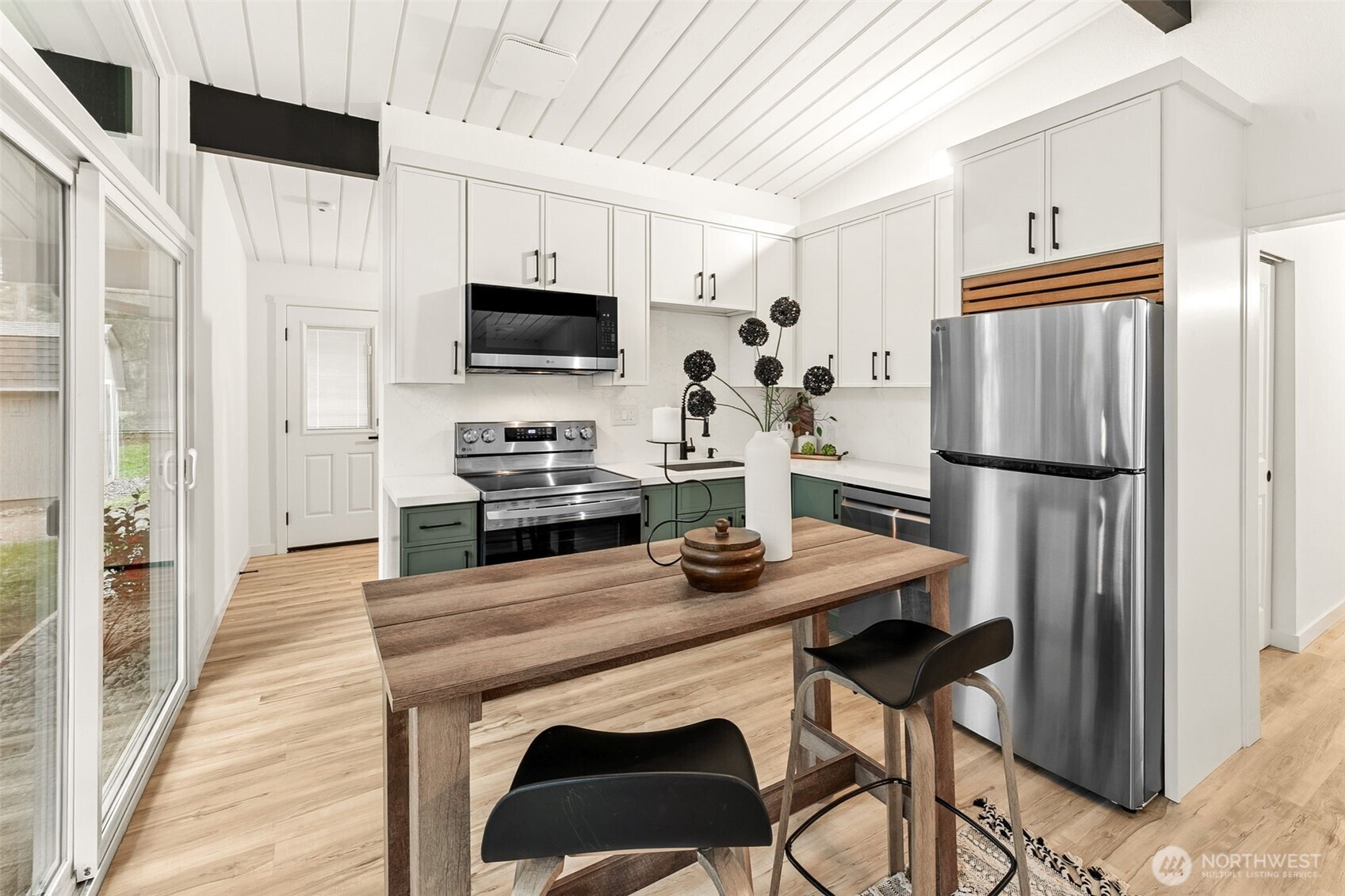 6198 Clover Valley Road Southeast Port Orchard, WA 98367 - Photo 9 of 34 a kitchen with stainless steel appliances granite countertop a refrigerator a stove a sink dishwasher and white cabinets with wooden floor