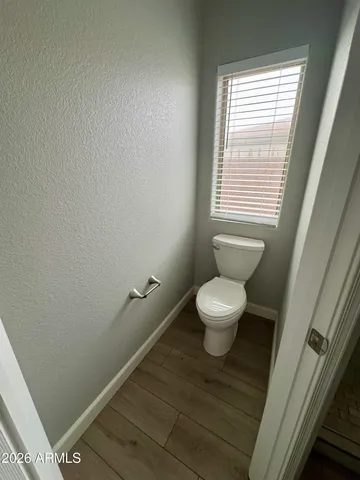a bathroom with a toilet and a window