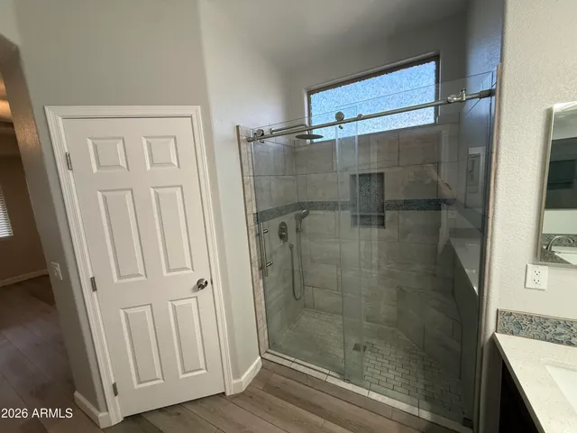 a bathroom with a glass door shower