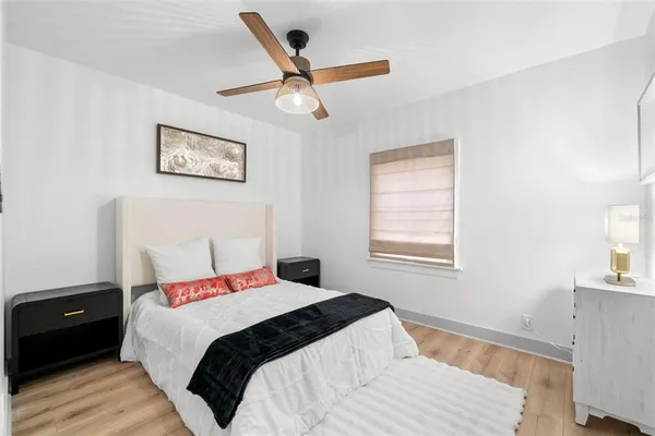 a bedroom with a large bed and a window