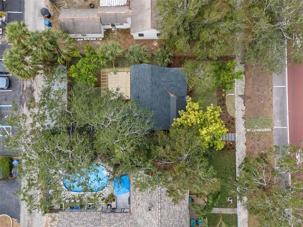 an aerial view of a house with a yard and garden