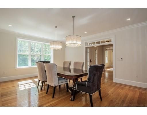 a dining room with furniture a chandelier and wooden floor