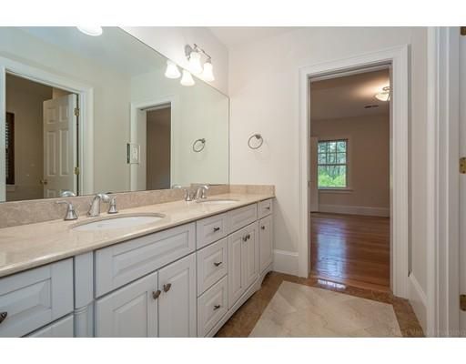 a bathroom with a granite countertop sink mirror and