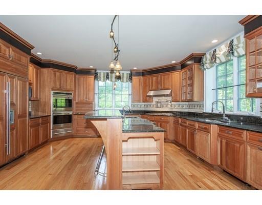 3 Valley Road Dover, MA 02030 - Photo 10 of 30 a kitchen with stainless steel appliances granite countertop a refrigerator a sink dishwasher a stove and a dining table with wooden floor