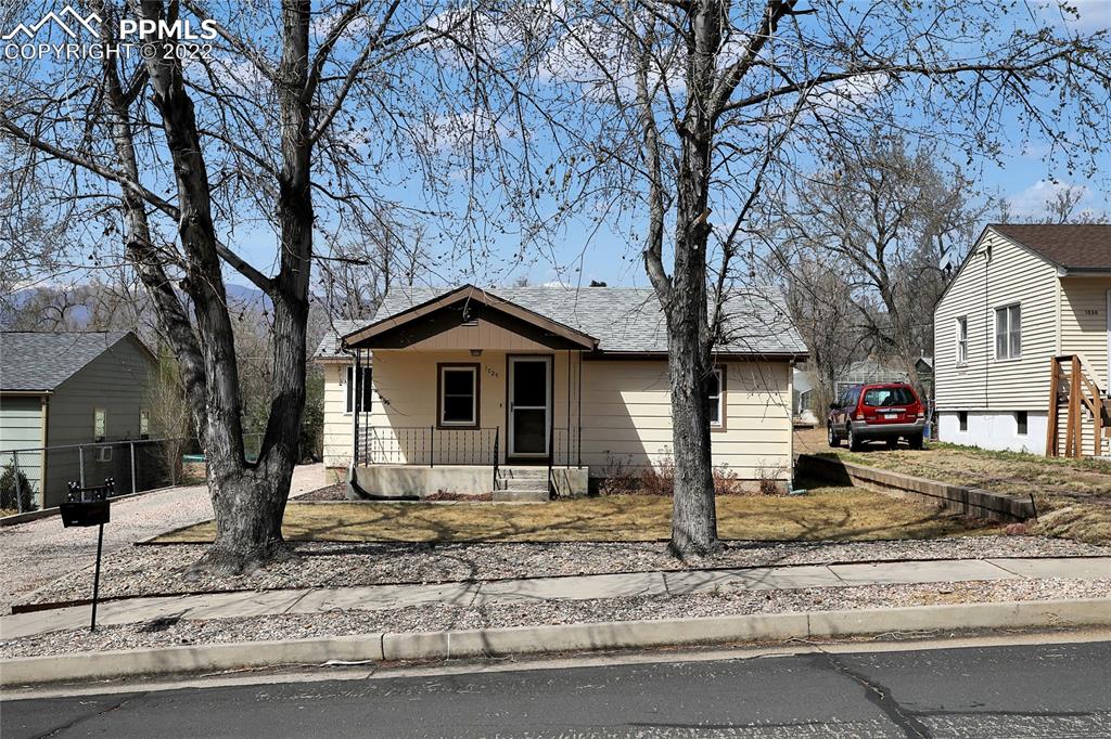 1024 Prairie Road Colorado Springs, CO 80909 - Photo 1 of 22 a front view of a house with garden