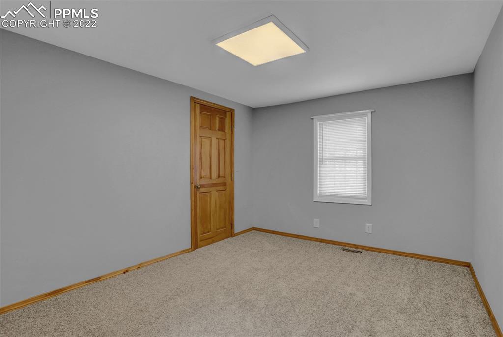 1024 Prairie Road Colorado Springs, CO 80909 - Photo 15 of 22 an empty room with windows