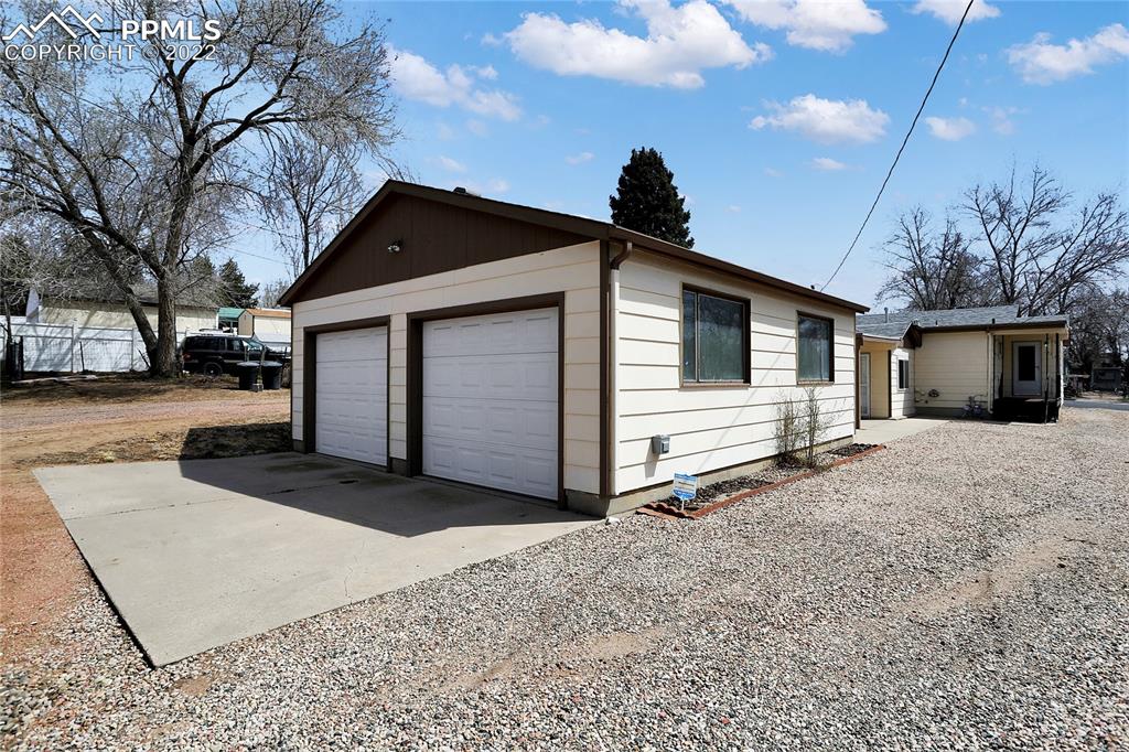1024 Prairie Road Colorado Springs, CO 80909 - Photo 4 of 22 a front view of house with yard and trees in the background