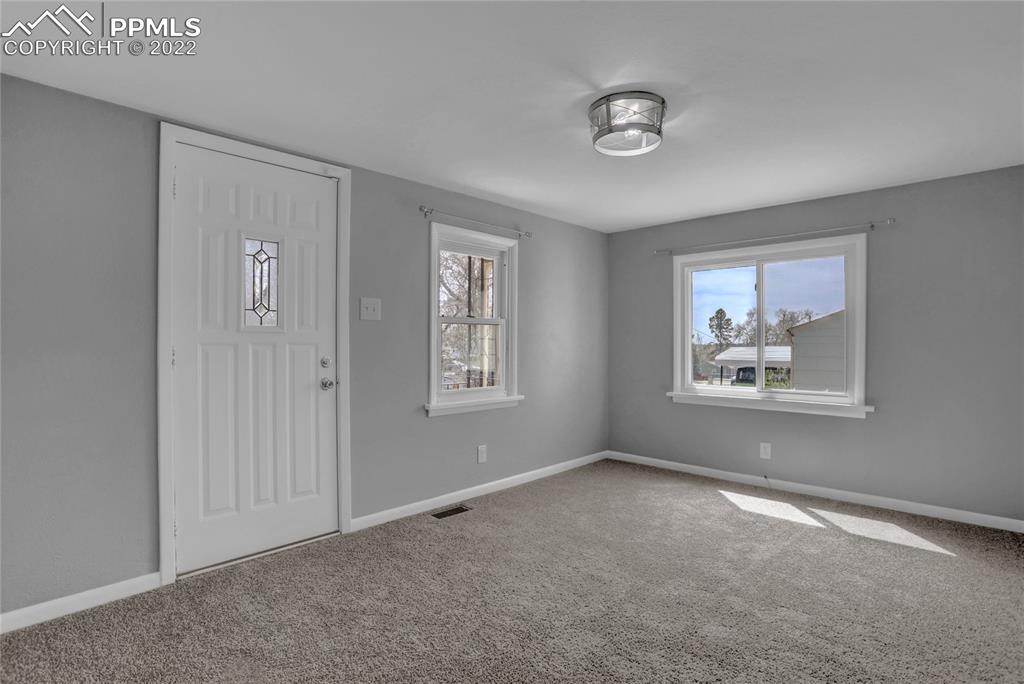 1024 Prairie Road Colorado Springs, CO 80909 - Photo 5 of 22 a view of an empty room with a window