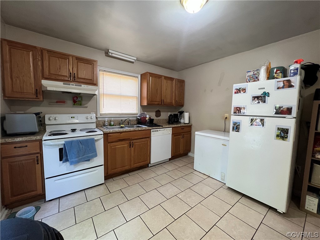 21205 Matoaca Road Petersburg, VA 23803 - Photo 6 of 10 a kitchen with cabinets a sink and white appliances