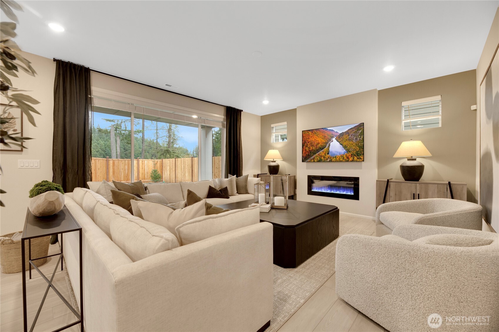 13627 60th Avenue West Edmonds, WA 98026 - Photo 9 of 29 a living room with furniture a large window and a fireplace