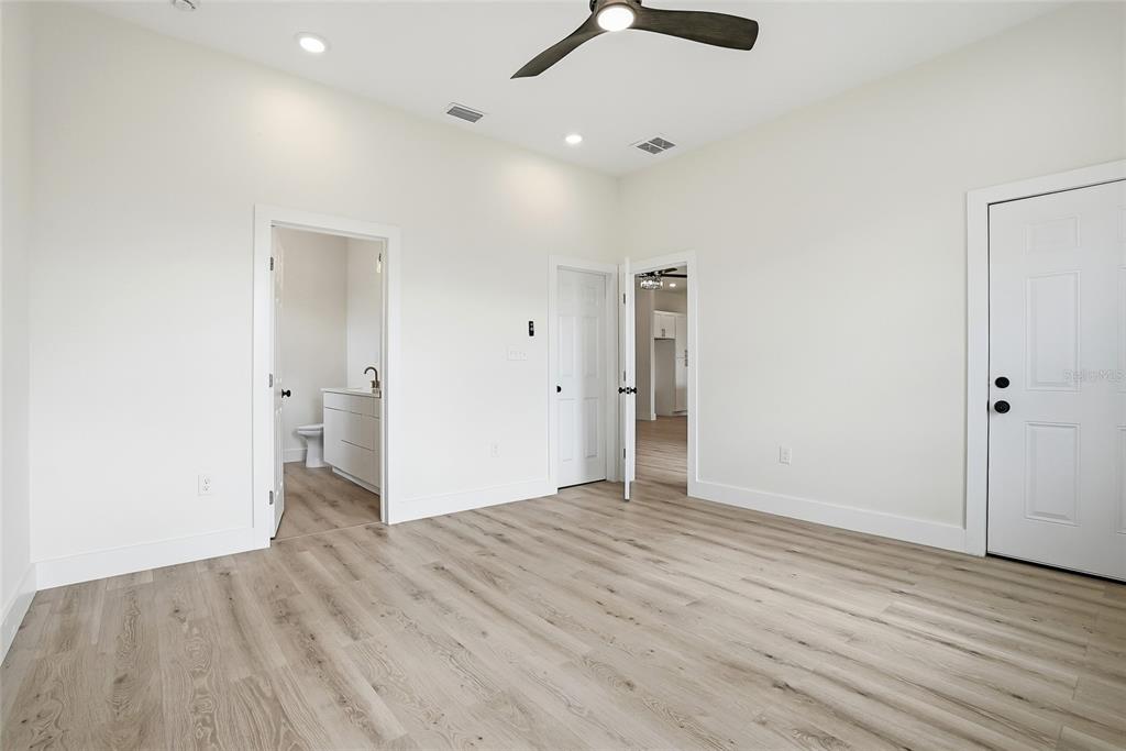 11256 Salters Street Spring Hill, FL 34609 - Photo 11 of 46 a view of an empty room with wooden floor