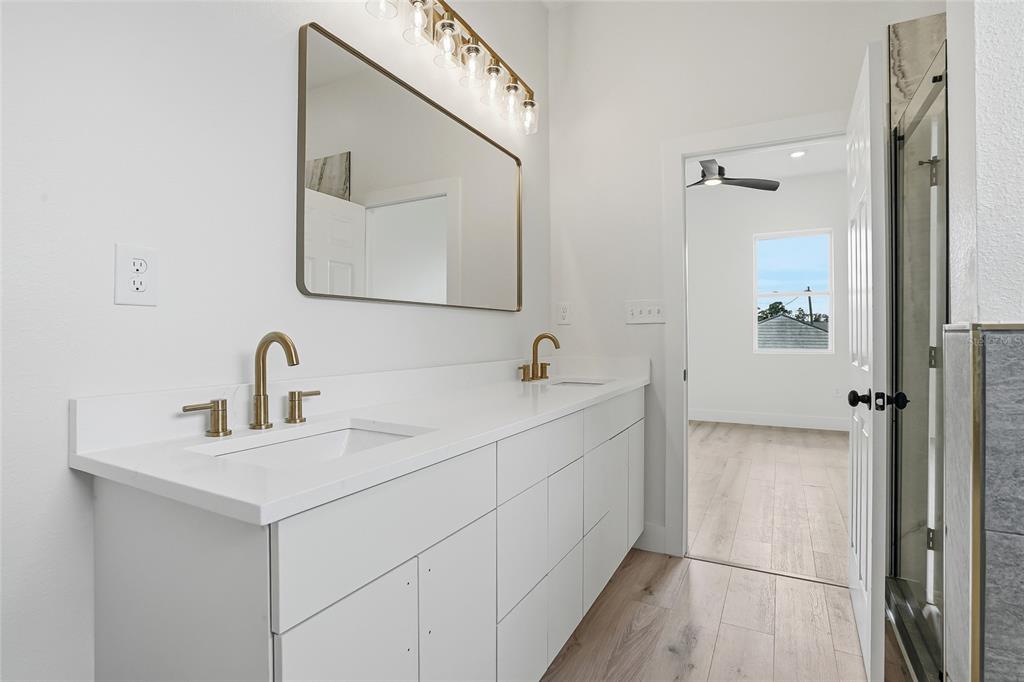 11256 Salters Street Spring Hill, FL 34609 - Photo 21 of 46 a bathroom with a double vanity sink mirror and