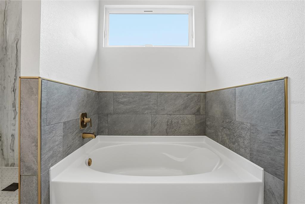 11256 Salters Street Spring Hill, FL 34609 - Photo 22 of 46 a white bath tub sitting in a bathroom
